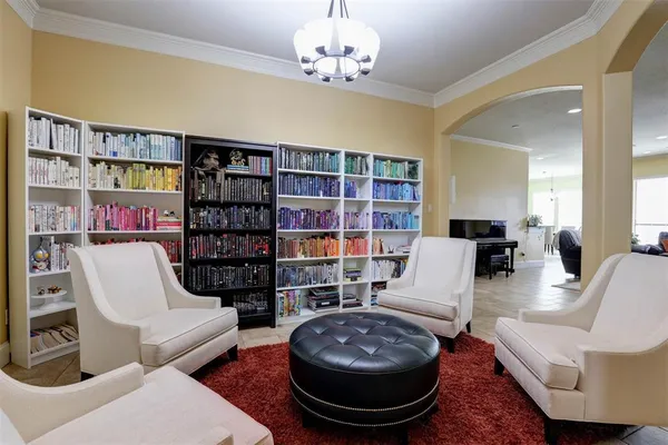 a living room with furniture and a book shelf