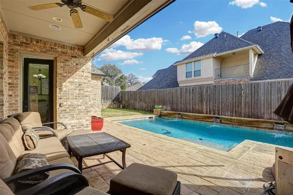 a backyard of a house with table and chairs
