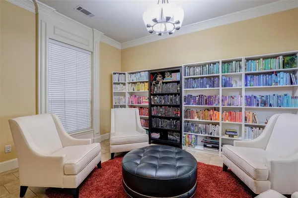 a living room with furniture and a book shelf