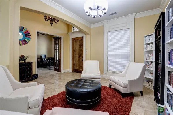 a living room with furniture and a chandelier
