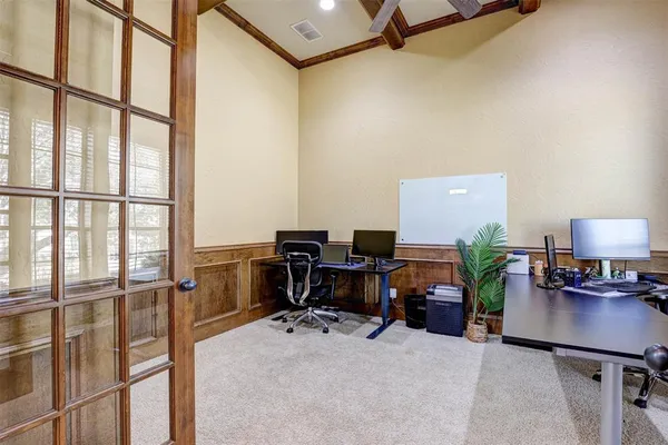 a view of a workspace with furniture and a window