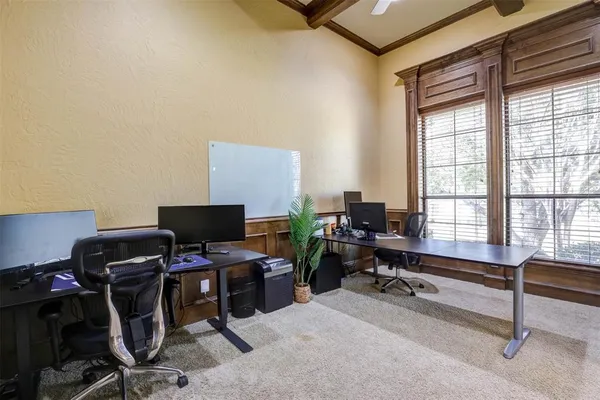 a view of a workspace with furniture and a window