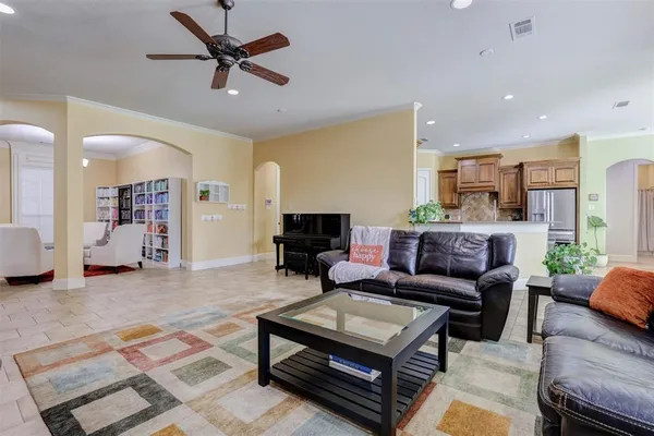 a living room with furniture and a view of kitchen