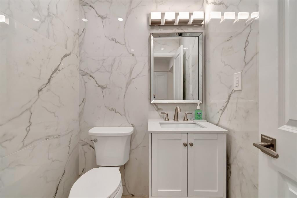5520 North Ocean Boulevard, Unit 210 Ocean Ridge, FL 33435 - Photo 14 of 40 a bathroom with a toilet sink and mirror