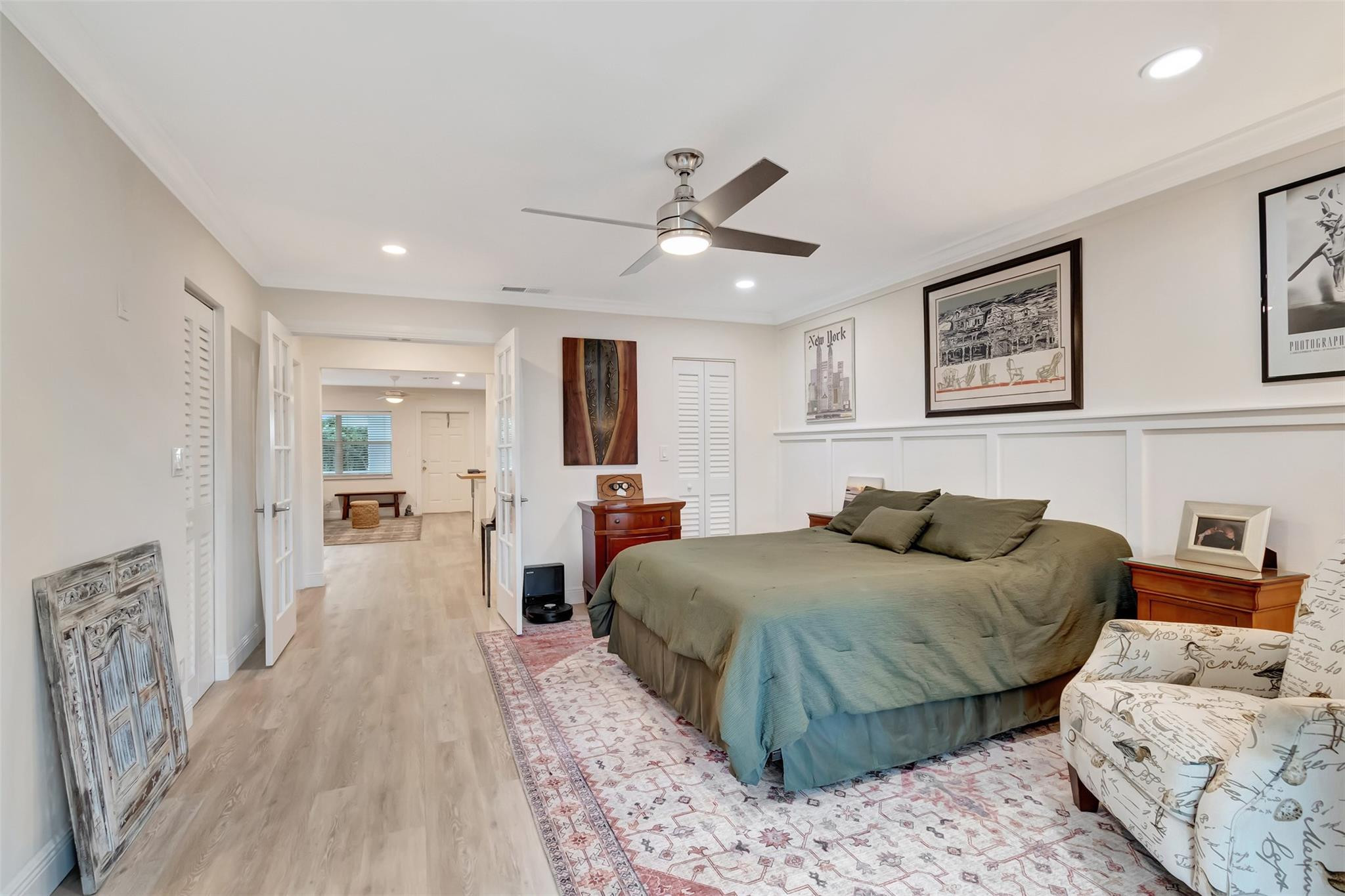 5520 North Ocean Boulevard, Unit 210 Ocean Ridge, FL 33435 - Photo 17 of 40 a bedroom with a large bed and a chandelier