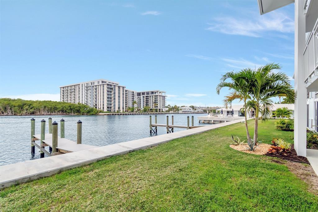 5520 North Ocean Boulevard, Unit 210 Ocean Ridge, FL 33435 - Photo 27 of 40 a view of a lake with a big yard and large trees