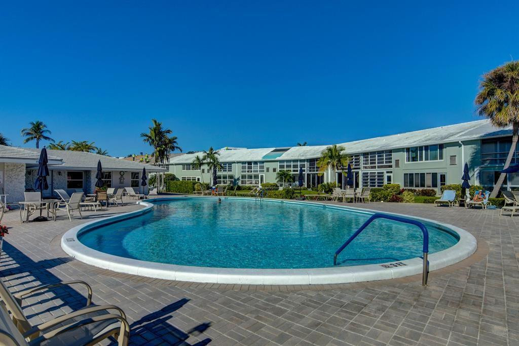 5520 North Ocean Boulevard, Unit 210 Ocean Ridge, FL 33435 - Photo 33 of 40 a view of a swimming pool with sitting area