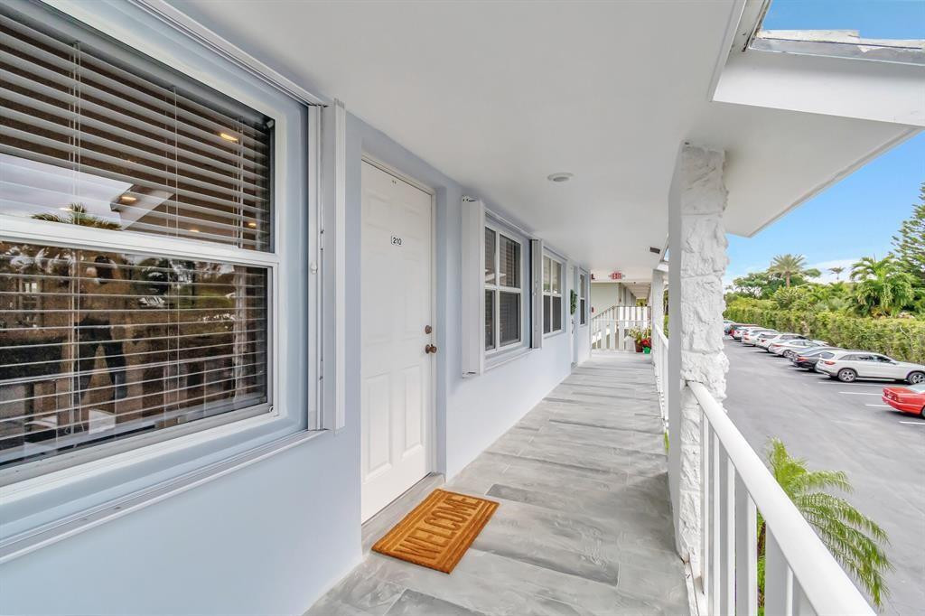 5520 North Ocean Boulevard, Unit 210 Ocean Ridge, FL 33435 - Photo 4 of 40 a view of a house with a porch