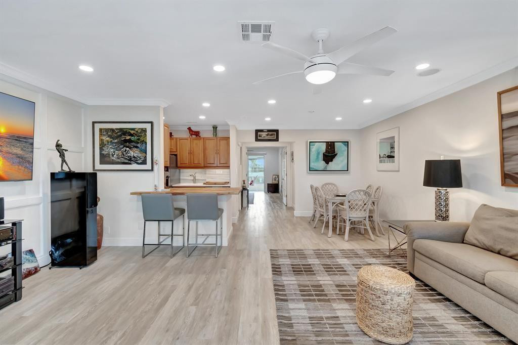 5520 North Ocean Boulevard, Unit 210 Ocean Ridge, FL 33435 - Photo 5 of 40 a living room with furniture and a wooden floor