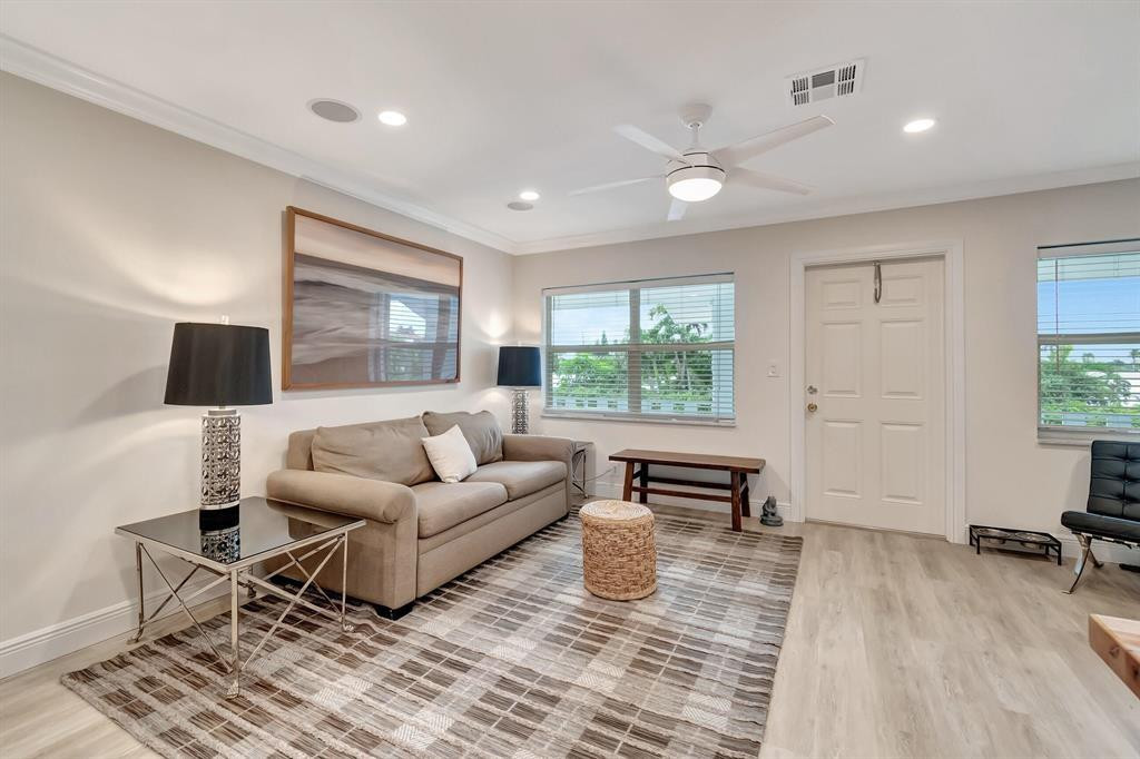 5520 North Ocean Boulevard, Unit 210 Ocean Ridge, FL 33435 - Photo 9 of 40 a living room with furniture and a wooden floor