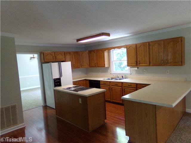 4111 Witherow Road Winston-Salem, NC 27106 - Photo 4 of 16 Kitchen. The kitchen is very spacious and has a lot of counter space. The island has a down draft Jenn-air stove with grill.