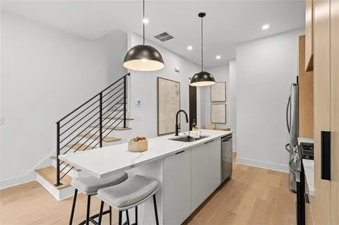 a kitchen with a sink stove and refrigerator