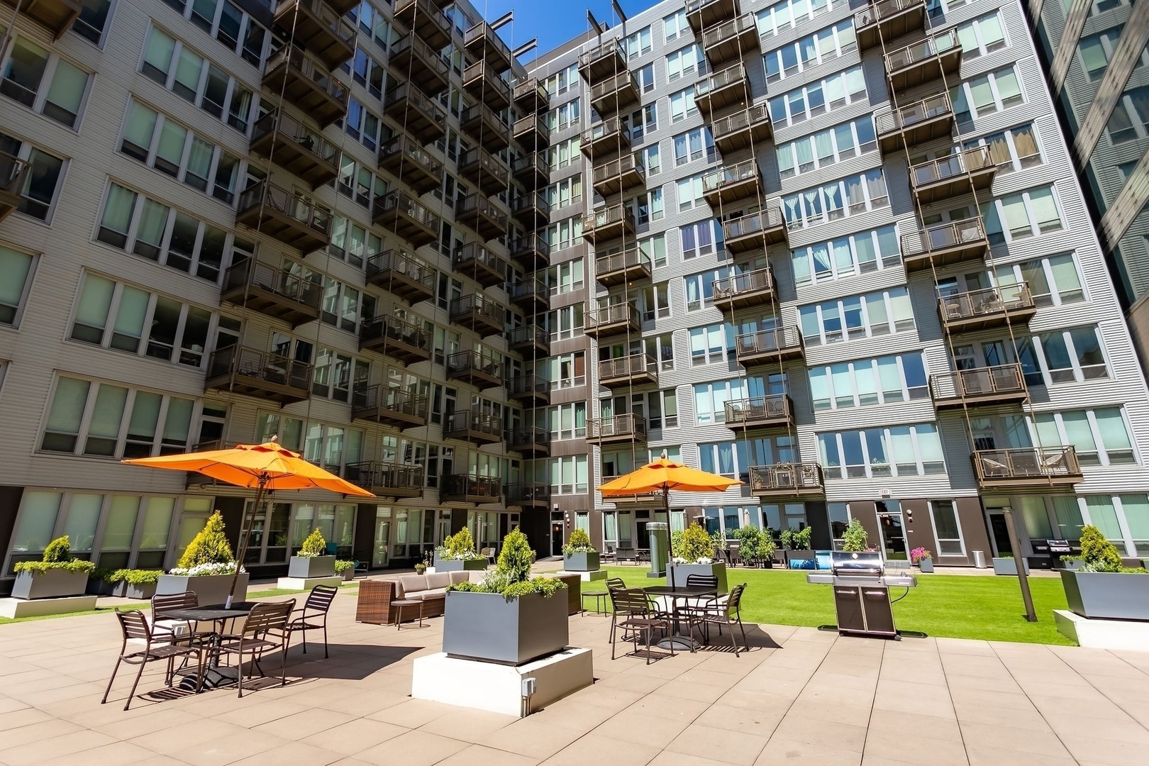 565 West Quincy Street, Unit 902 Chicago, IL 60661 - Photo 16 of 26 a view of a building with sitting area and garden