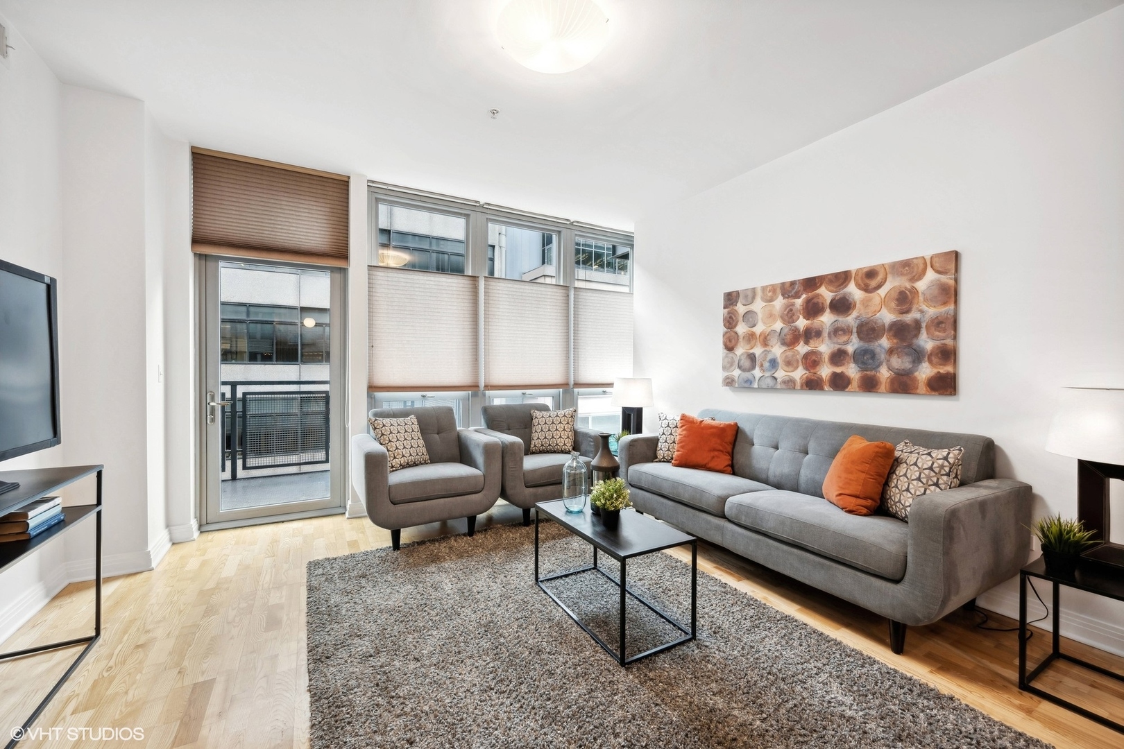 565 West Quincy Street, Unit 902 Chicago, IL 60661 - Photo 4 of 26 a living room with furniture and a large window