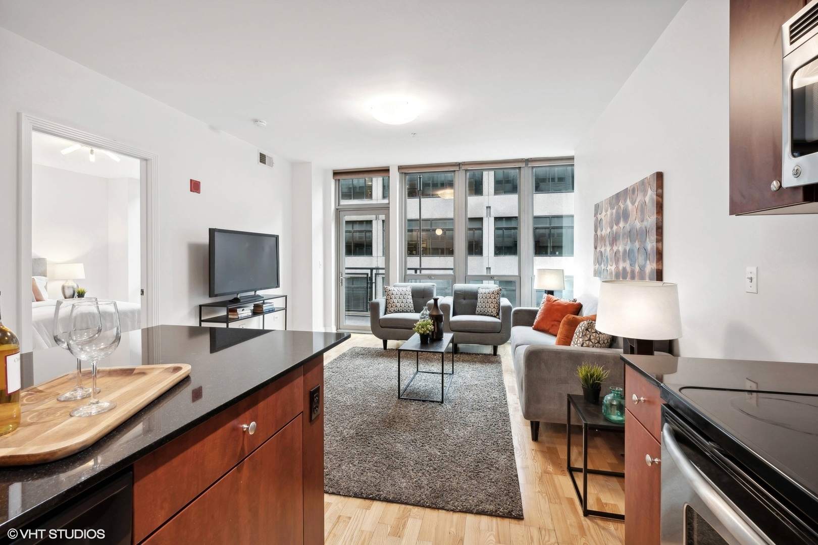 565 West Quincy Street, Unit 902 Chicago, IL 60661 - Photo 6 of 26 a living room with fireplace furniture and a flat screen tv