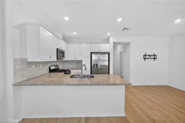an empty room with a ceiling fan and a fan