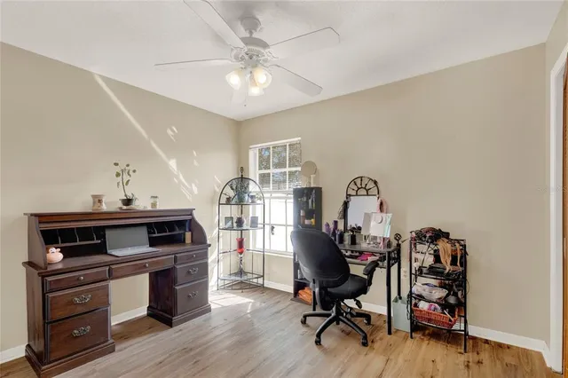 a view of a workspace with furniture and a window