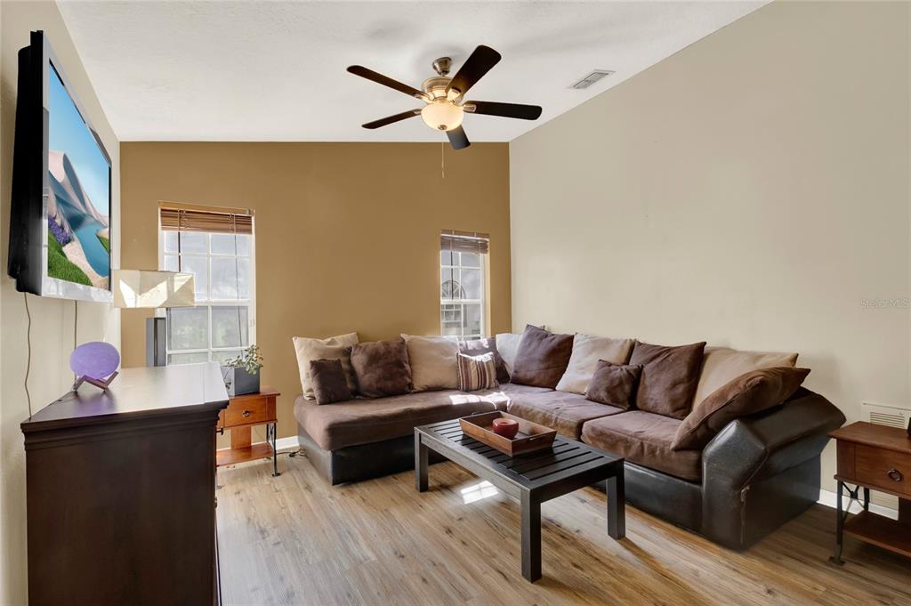 1007 Tony Circle St. Cloud, FL 34772 - Photo 8 of 20 a living room with furniture and a wooden floor