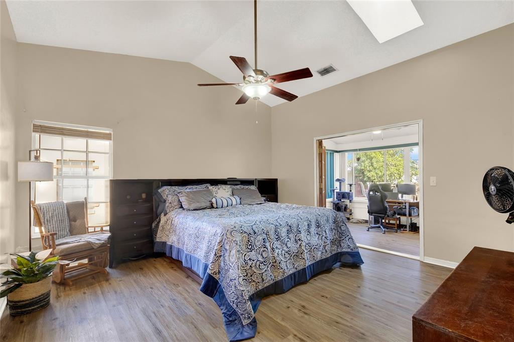 1007 Tony Circle St. Cloud, FL 34772 - Photo 9 of 20 a bedroom with a bed a ceiling fan and a large window