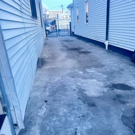 a view of a house with wooden fence