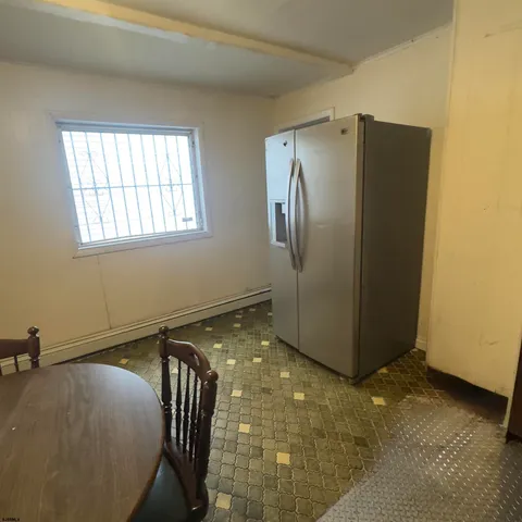 a view of a refrigerator in kitchen and glass windows