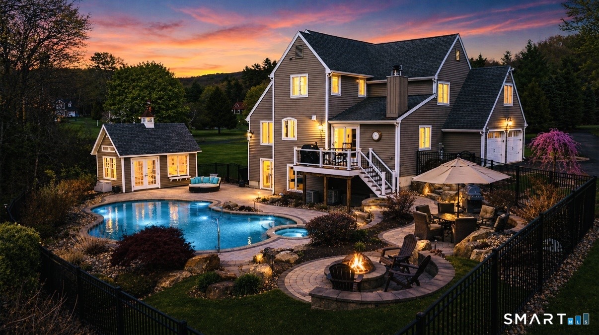 a front view of a house with swimming pool and outdoor seating