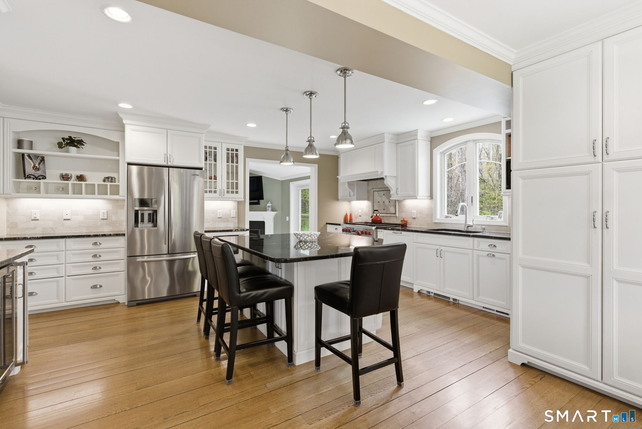 10 Ryans Way Burlington, CT 06013 - Photo 11 of 35 a kitchen with stainless steel appliances a dining table chairs and wooden floor
