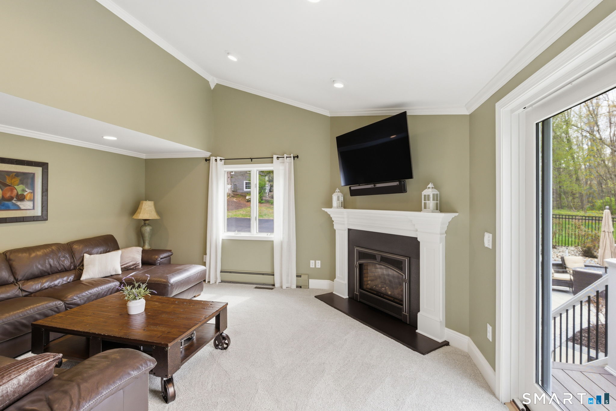 10 Ryans Way Burlington, CT 06013 - Photo 18 of 35 a living room with furniture a fireplace and a flat screen tv