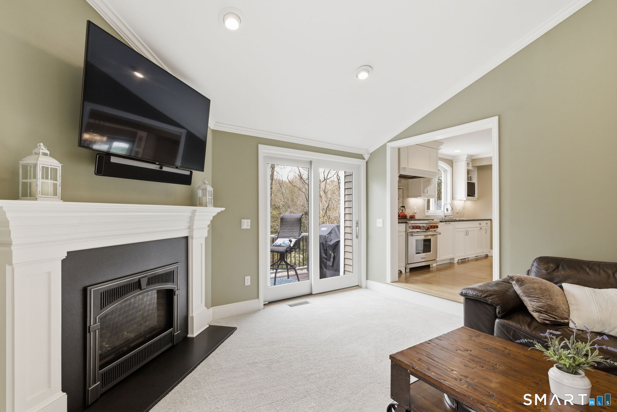 10 Ryans Way Burlington, CT 06013 - Photo 19 of 35 a living room with furniture a flat screen tv and a fireplace