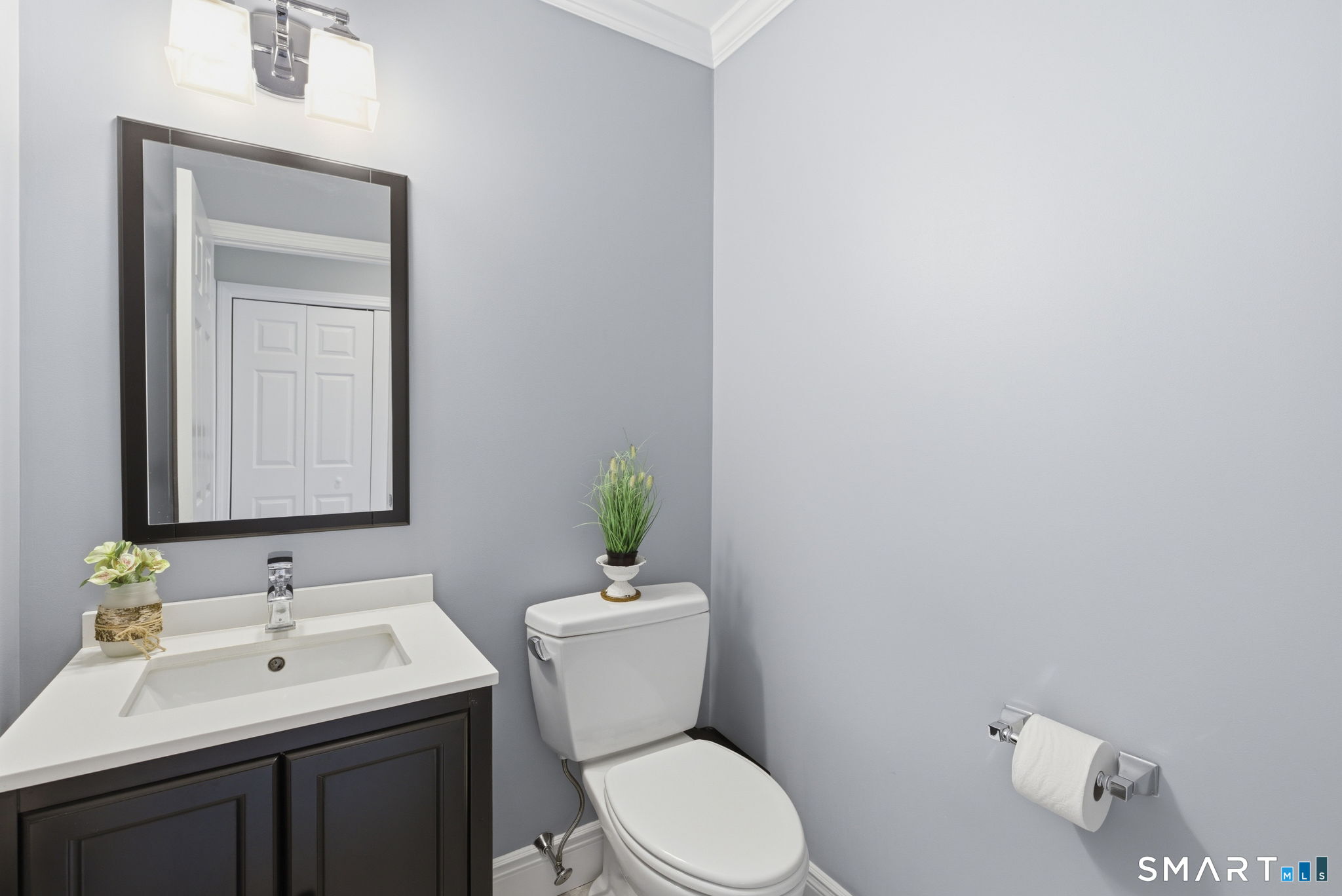 10 Ryans Way Burlington, CT 06013 - Photo 20 of 35 a bathroom with a toilet a sink a mirror and vanity