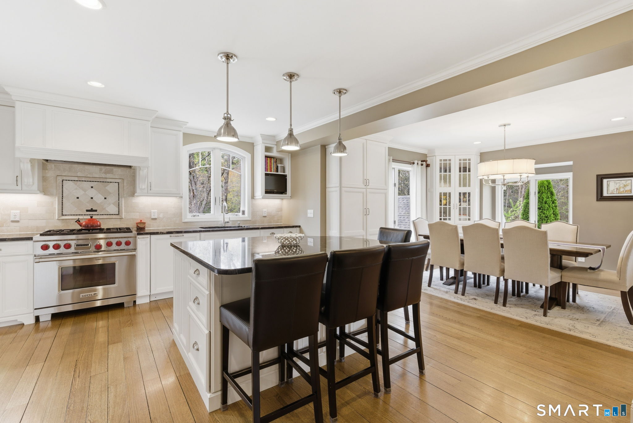 10 Ryans Way Burlington, CT 06013 - Photo 10 of 35 a kitchen with stainless steel appliances granite countertop a stove a sink dishwasher a dining table and chairs with wooden floor