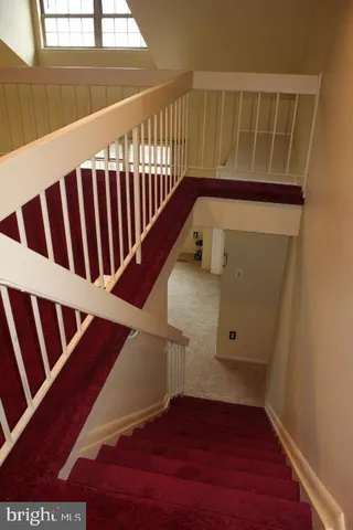 a bedroom with a bed and a ceiling fan