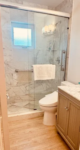 a bathroom with a toilet and a shower
