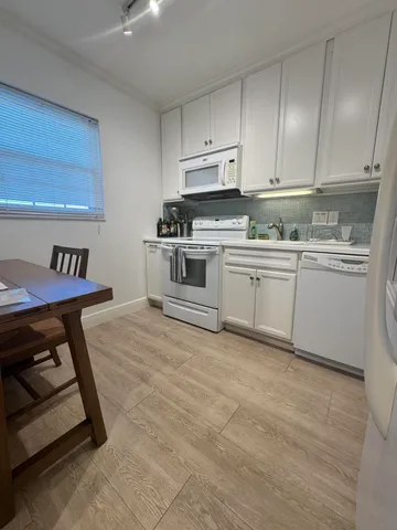 a kitchen with cabinets and appliances