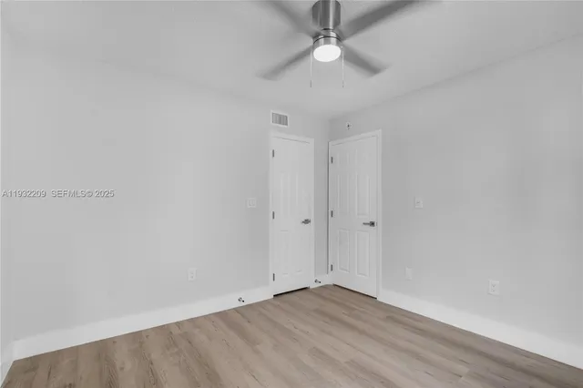 a view of an empty room with a fan