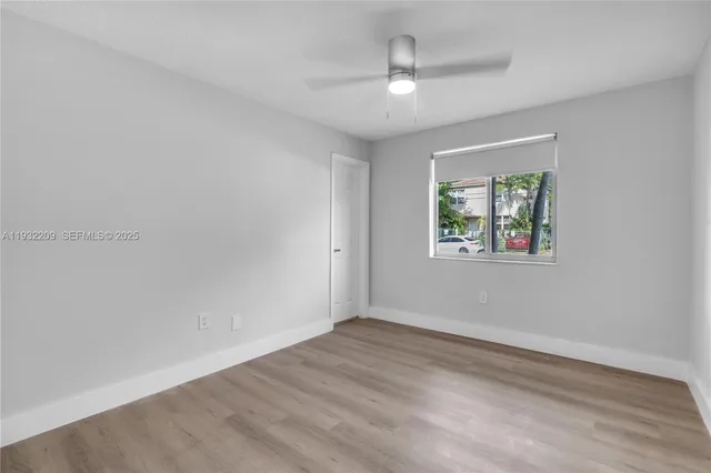 wooden floor in an empty room with a window