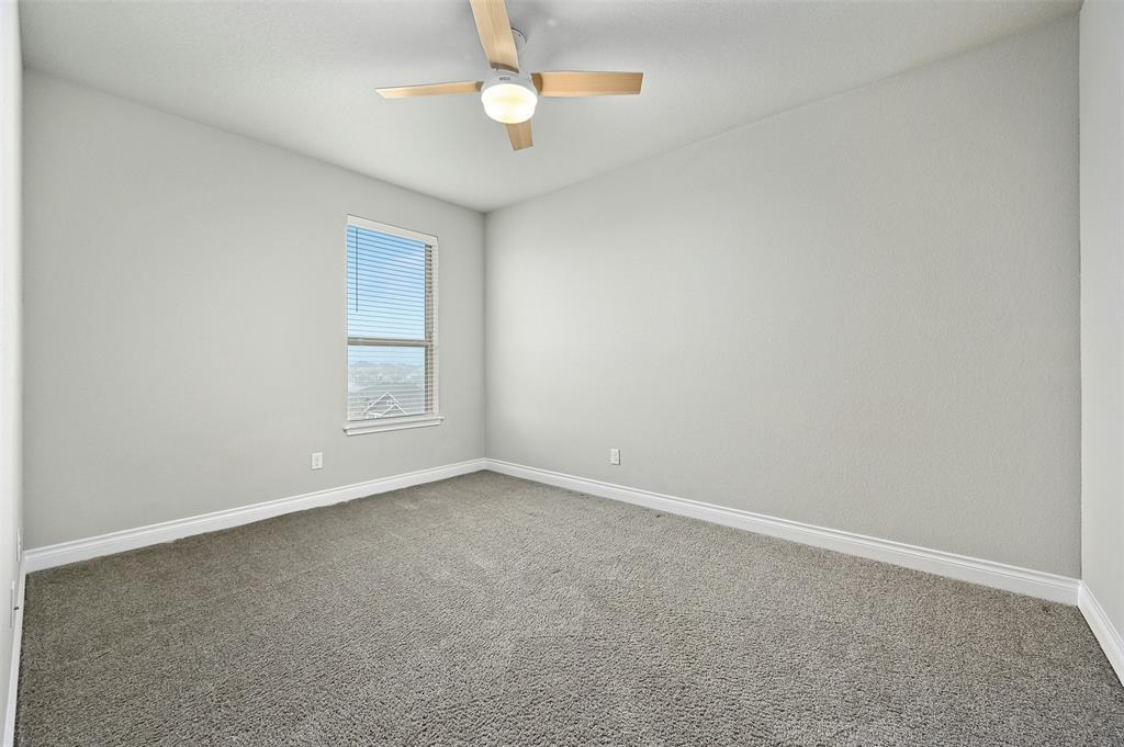 132 Santa Maria Street Georgetown, TX 78628 - Photo 28 of 36 Empty room featuring dark carpet and a ceiling fan