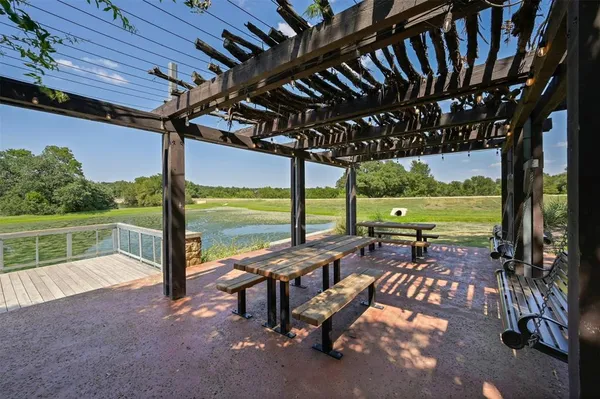 a swimming pool with outdoor seating and yard