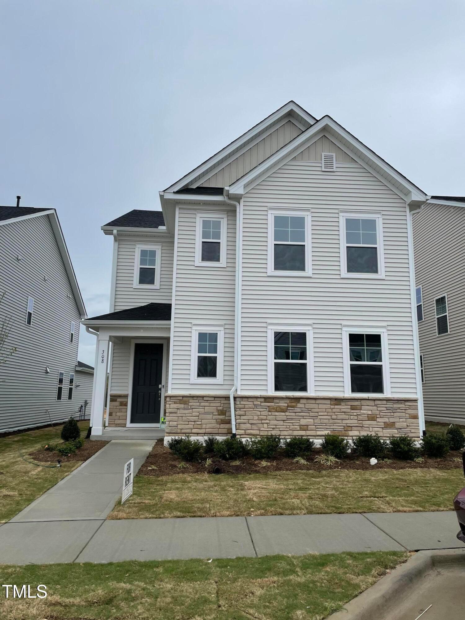308 Edge Of Auburn Boulevard Raleigh, NC 27610 - Photo 1 of 23 a front view of a house with a yard