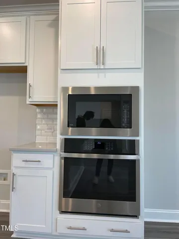 a stove top oven sitting inside of a kitchen