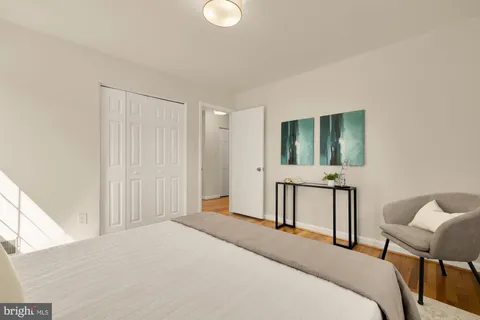 a bedroom with a bed a table and chair