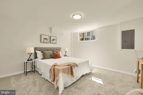 a bedroom with a bed and wall painting