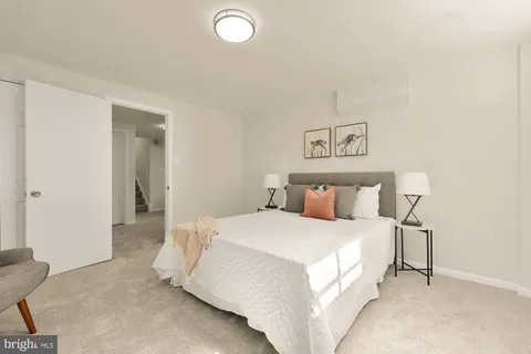 a bedroom with a bed and a lamp