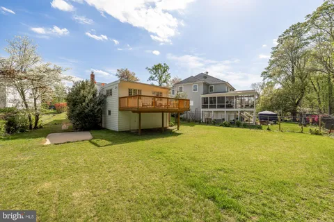 a view of a house with a yard and sitting area