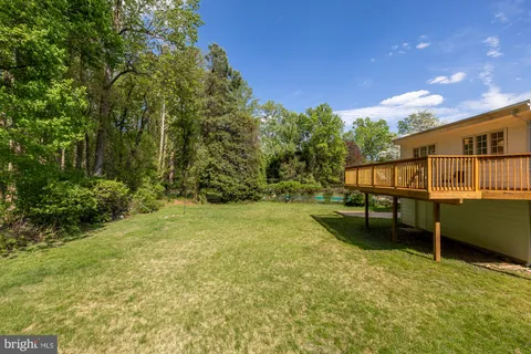 a view of a yard with wooden fence