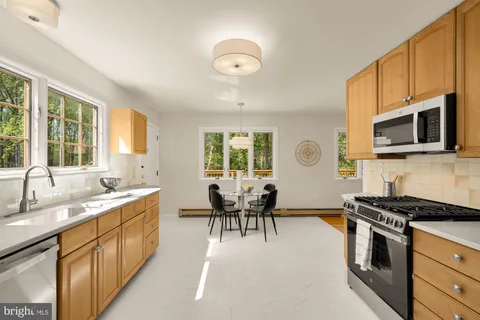 a kitchen with stainless steel appliances granite countertop a stove a sink dishwasher a microwave oven with granite countertops and cabinets