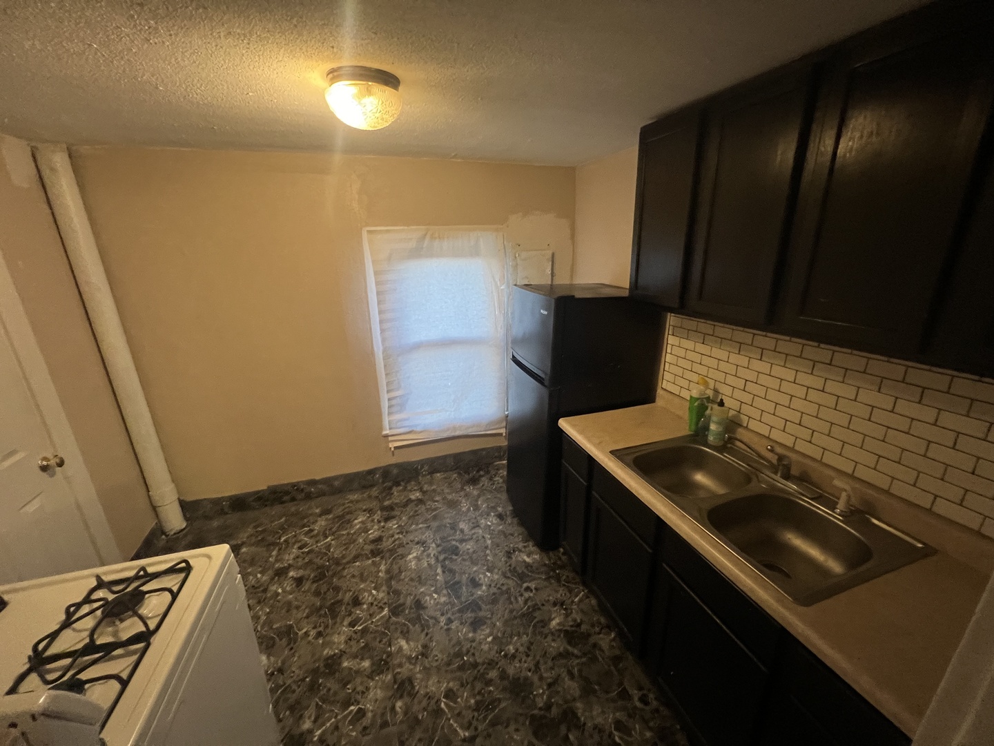 307 South 4th Avenue, Unit 3 Kankakee, IL 60901 - Photo 7 of 9 a kitchen with a stove and a refrigerator