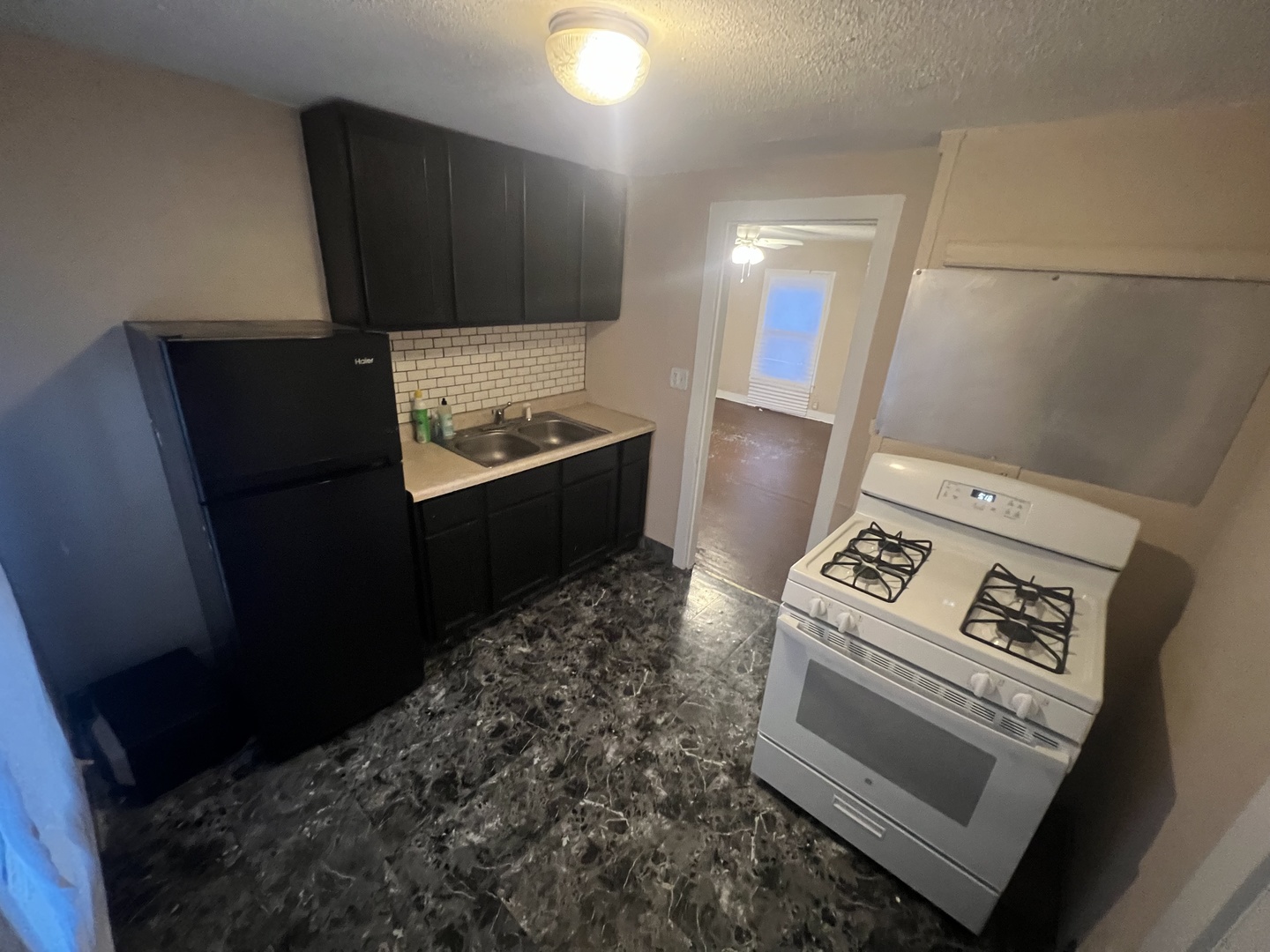 307 South 4th Avenue, Unit 3 Kankakee, IL 60901 - Photo 8 of 9 a kitchen with granite countertop a stove and a refrigerator