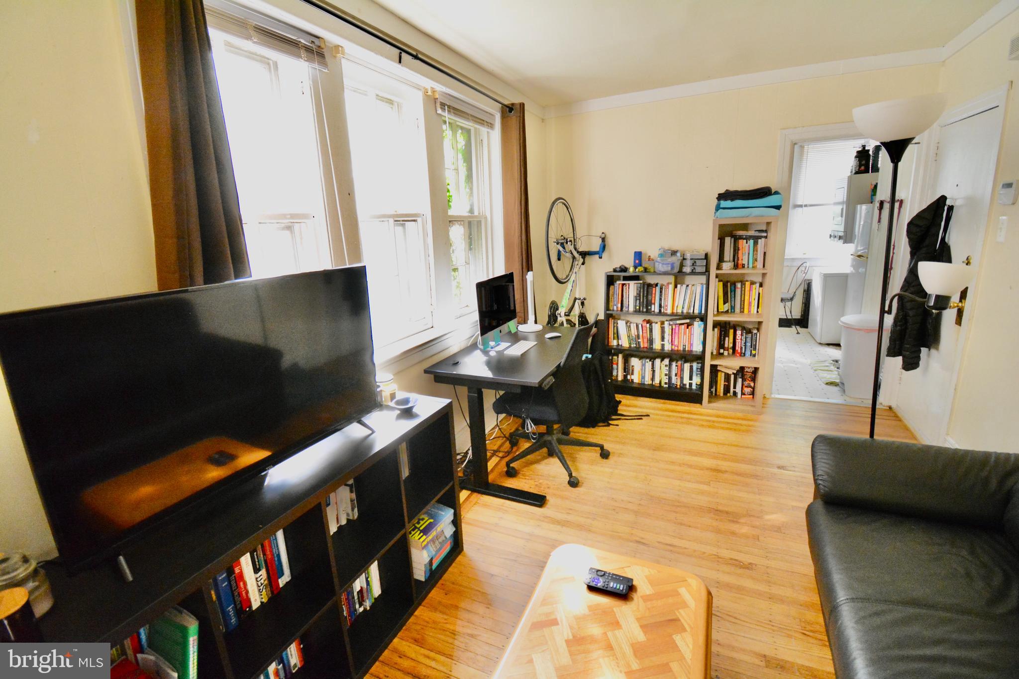 506 West Coulter Street, Unit 1 Philadelphia, PA 19144 - Photo 1 of 11 a living room with furniture and a flat screen tv