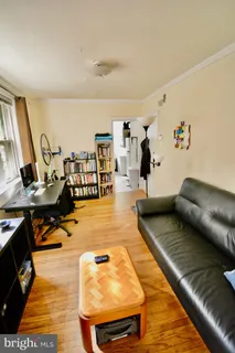 a living room with lots of furniture and painting on the wall